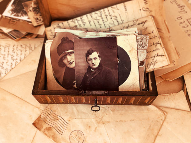 Old letters and photos Overhead image of a wooden box with old letters and photos. handwriting photos stock pictures, royalty-free photos & images