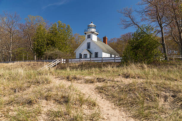 Old Mission point lighthouse Old Mission point lighthouse in Old mission pennisula, Traverse City, Michigan on a nice blue sky background. Mission Point Lighthouse, built 1870, Mission Peninsula in Grand Traverse Bay, Michigan. peninsula stock pictures, royalty-free photos & images