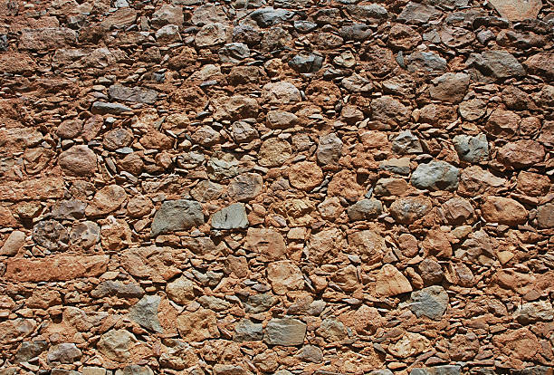 Old mud and rock wall stock photo