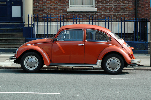 Liverpool, England - April 28, 2007:
Old orange Volkswagen Beetle in the street