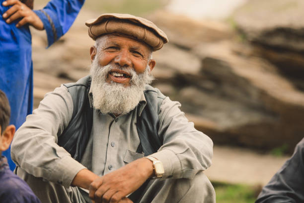 Old Pakistani Man with White Beard in Traditional Pakol stock photo