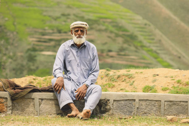 Old Pakistani Man with White Beard in Traditional Pakol stock photo