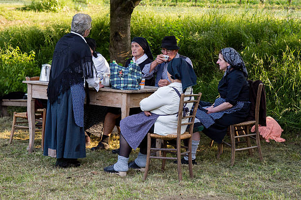 Old people talking in traditional peasant clothing stock photo