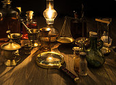 still life with the image of pharmacy supplies on a wooden table in the light of an oil lamp