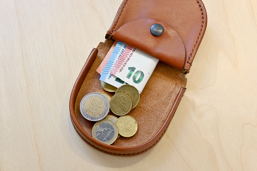 Old purse with Euro coins and Euro banknotes