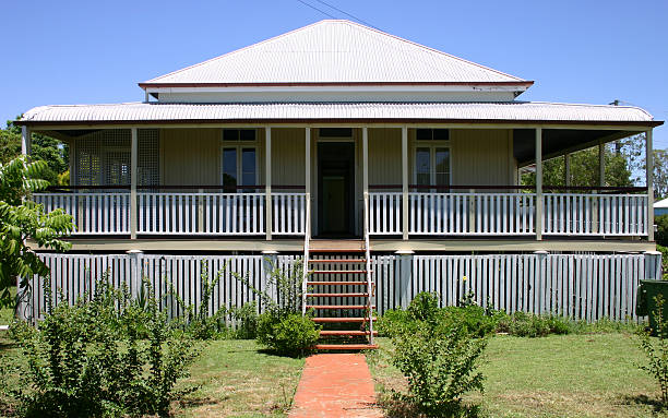 Old Queenslander cottage A small old wooden house with a corrugated iron roof and verandahs, built in what is known as an "Old Queenslander" style. external wall covering stock pictures, royalty-free photos & images