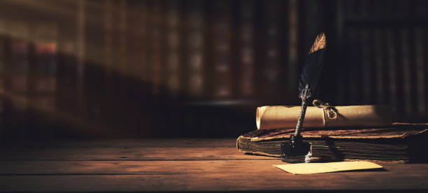 old quill pen with inkwell and papers on wooden desk against vintage bookcase. retro style. banner copy space stock photo