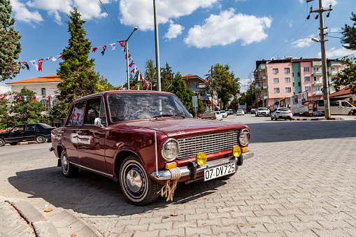 Kemer, TURKEY - 08. 25. 2021: Old, Red colored Classical Car made by Fiat and Tofas in Turkey named Murat 124, Tofas Serce (sparrow) parked.