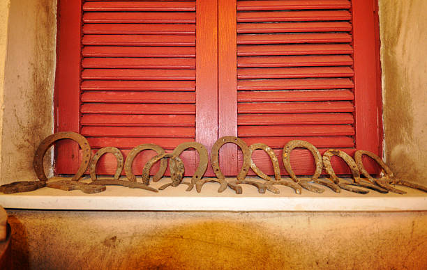 Old Rusted horeshoes on a window sill stock photo