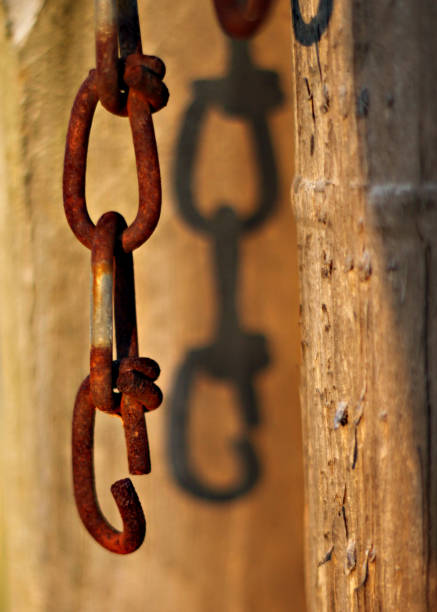 Old rusty chain hanging with a a broken link stock photo