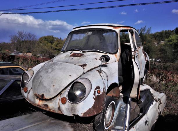 Old scrapped car, Abandoned retro car for recycling in waste disposal site stock photo