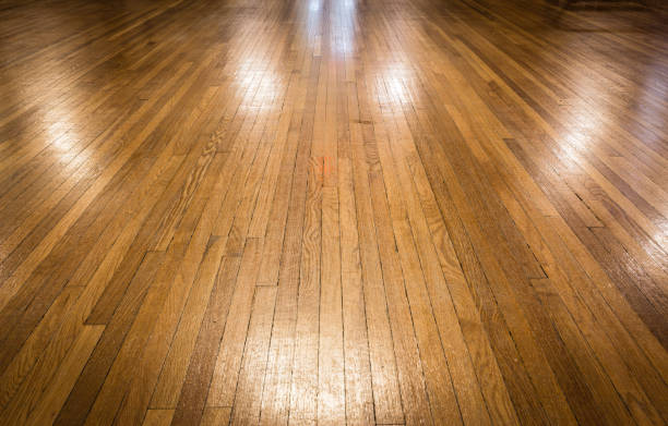old shiny polished hardwood floor. horizontal image of a bare vintage shiny and polished hardwood floor great for a background. hardwood stock pictures, royalty-free photos & images