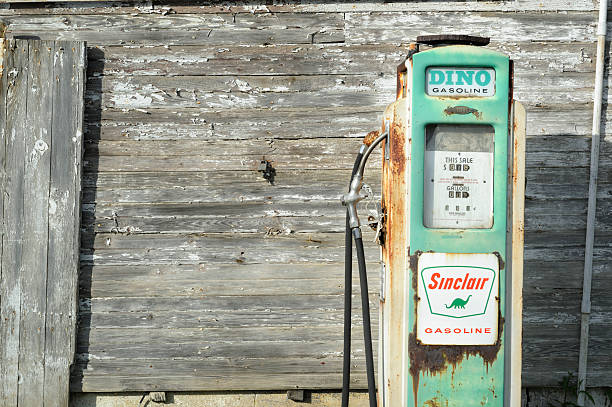 Old Sinclair Gas Pump and Weathered Farm Building stock photo