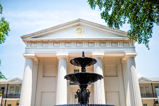 Little Rock, USA - June 4, 2019: Old State House Museum old capitol building with neoclassical columns architecture and water fountain looking up blue sky