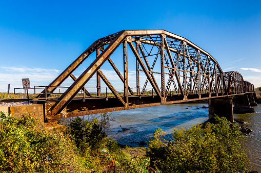 An Iconic Old Metal Truss Railroad Bridge over a Large River.