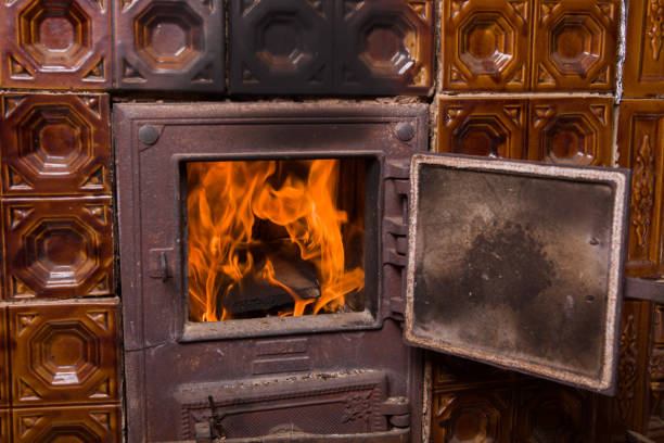 Old tiled stove and fire stock photo