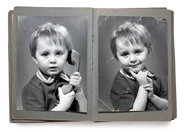 Old times style photobook of a child posing with a telephone Old album with the children's shabby photos (isolated) photography photos stock pictures, royalty-free photos & images