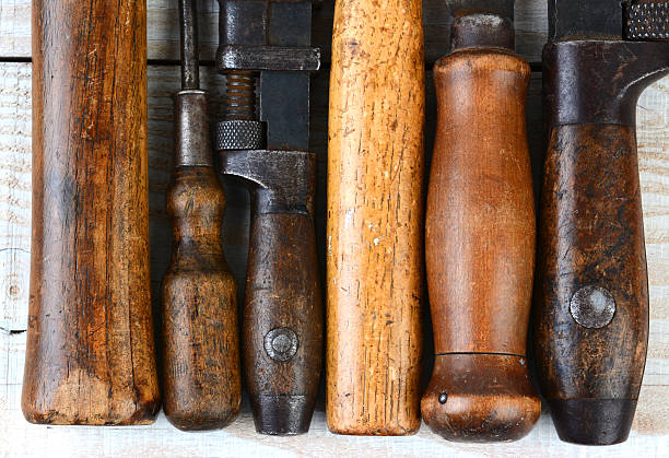 Closeup of the wooden handles of a group of old tools. Horizontal...