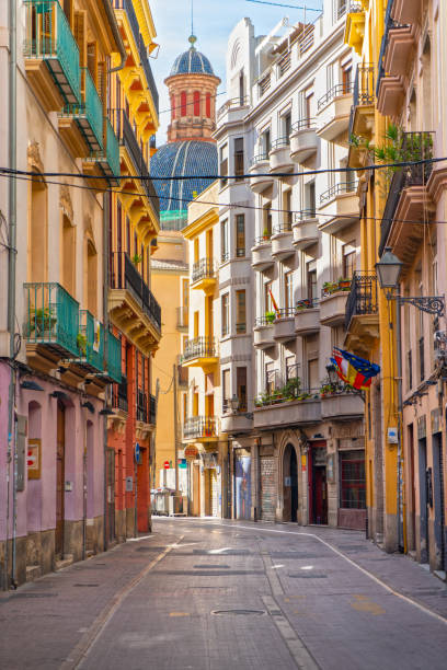 Old Town colorful street in Valencia, Spain Old Town streets  in Valencia with colorful cathedral dome on the background, Valencia, Spain comunidad autonoma de valencia stock pictures, royalty-free photos & images