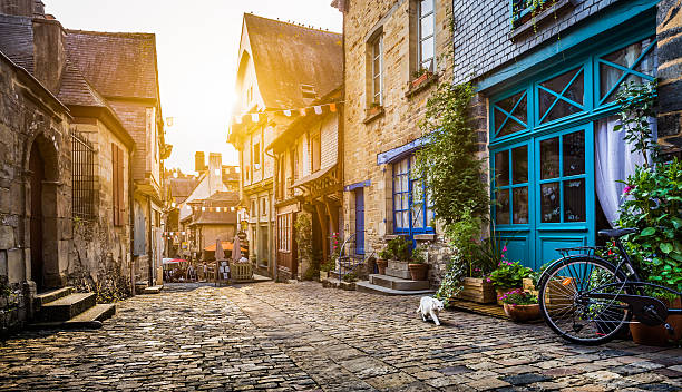 Old town in Europe at sunset with retro vintage filter Old town in Europe at sunset with retro vintage Instagram style filter and lens flare effect. brittany france stock pictures, royalty-free photos & images