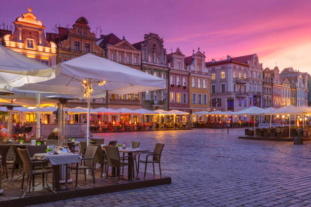 Old town of Poznan, Poland Restaurants light up in the evening in the old town of Poznan as the sun sets. poznan stock pictures, royalty-free photos & images