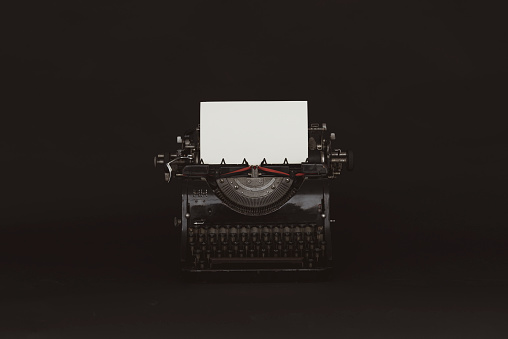 Old typewriter on the black background.