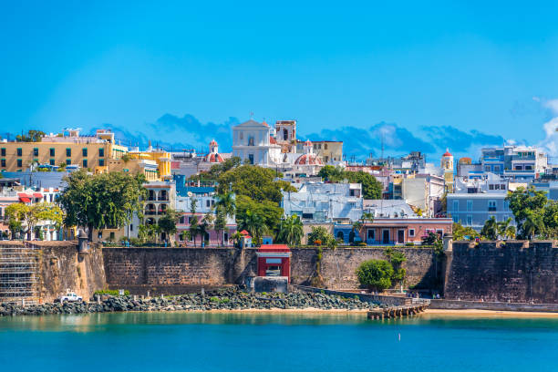 Old Wall and Colorful Buildings Colorful, historical buildings on the coast of Old San Juan, Puerto Rico puerto rico stock pictures, royalty-free photos & images
