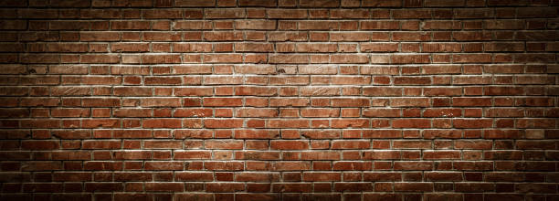 Old wall background with stained aged bricks Old wall background with stained aged bricks and spotlight brick wall stock pictures, royalty-free photos & images