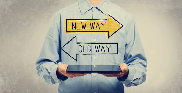 Old way or new way with man holding a tablet Old way or new way with young man holding a tablet computer old vs new stock pictures, royalty-free photos & images