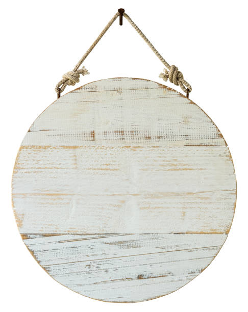 old weathered, white, wood, circular sign/signboard panel hanging by an old rope, hanging from a rusty nail, against an isolated white background. clipping path included. - wooden sign board against white imagens e fotografias de stock