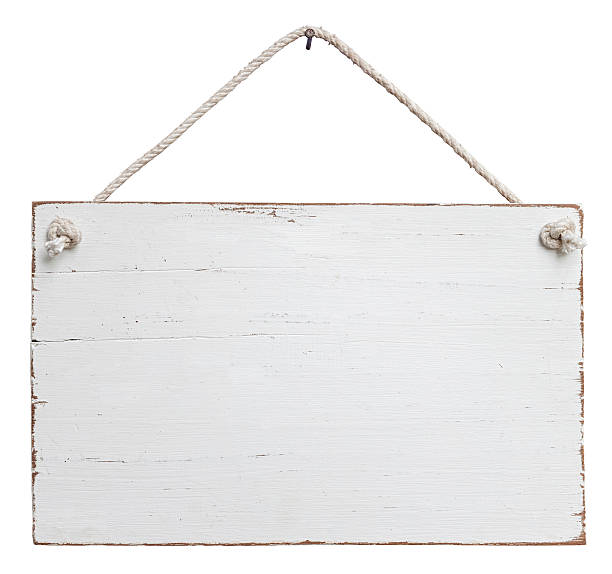 Old, white weathered signboard hanging by a string stock photo