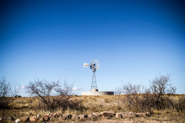 Old Windmill In Desert In Clear Sky stock photo