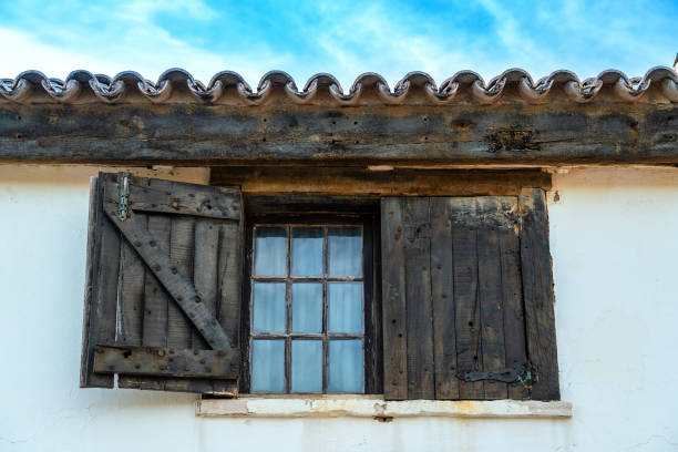 Old window with open wooden shutters. Rural architecture of Lisbon, Portugal stock photo