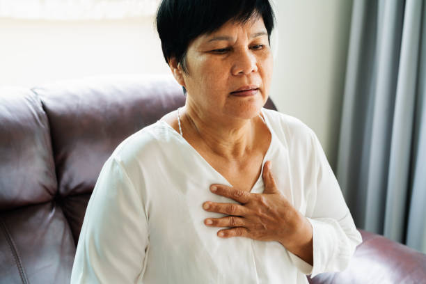old woman having heart attack and grabbing her chest old woman having heart attack and grabbing her chest chest pain stock pictures, royalty-free photos & images
