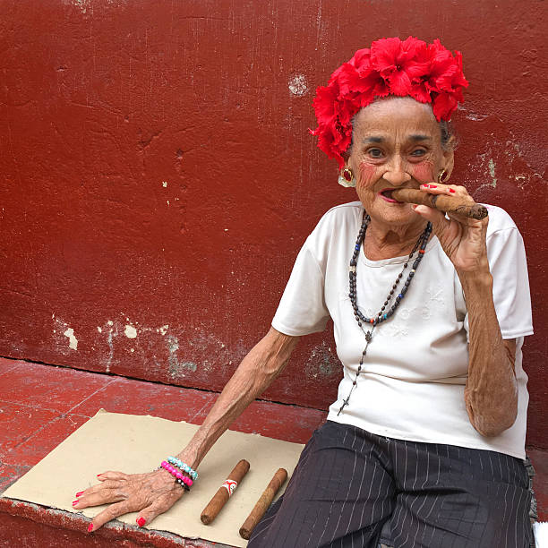 Old woman smoking cigar stock photo