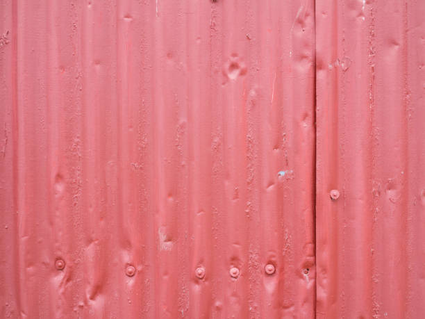 Old worn red corrugated steel texture on exterior wall. stock photo