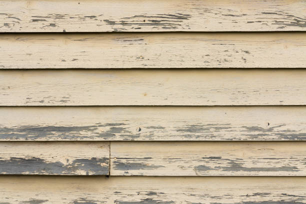 Old worn wood texture on exterior house wall. stock photo
