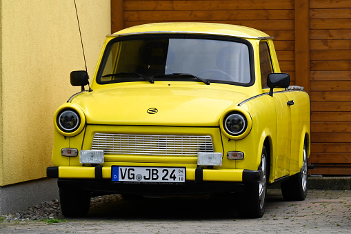 Pudagla, Germany, May 11, 2022 - Old yellow Trabant 601s car parked on a street side