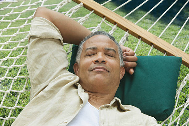 older man sleeping on a hammock - retirement overview bildbanksfoton och bilder