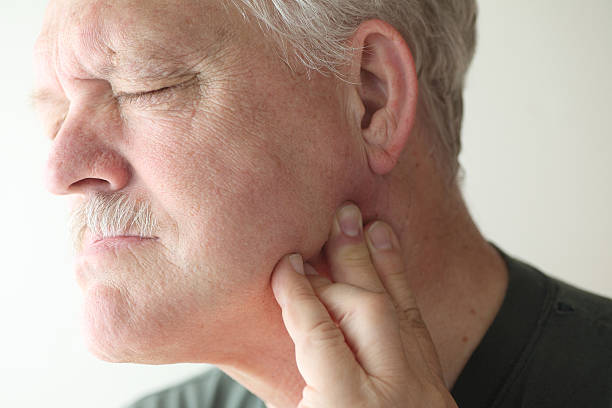 Older man with painful jaw stock photo
