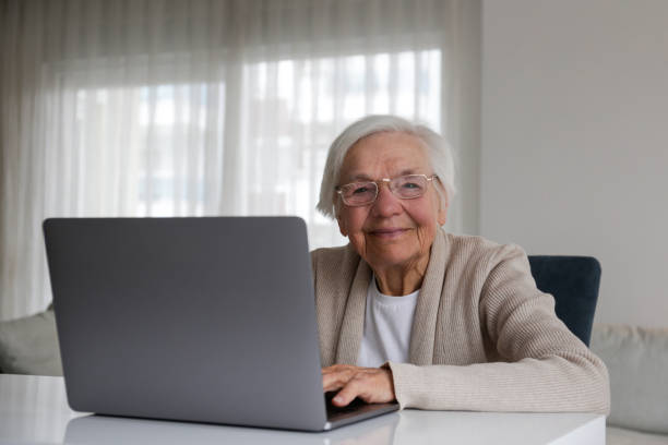 Older senior woman with laptop. stock photo