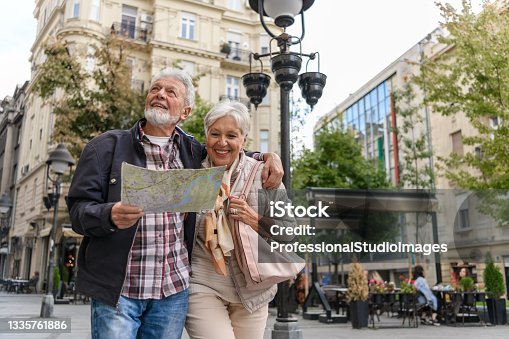 istock Older Travelers are Sightseeing the City During a Vacation Using a City Map. 1335761886
