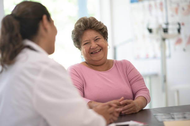 Older Woman talking with the Doctor stock photo Older woman speaking and consulting with the doctor about her concerns general practitioner stock pictures, royalty-free photos & images