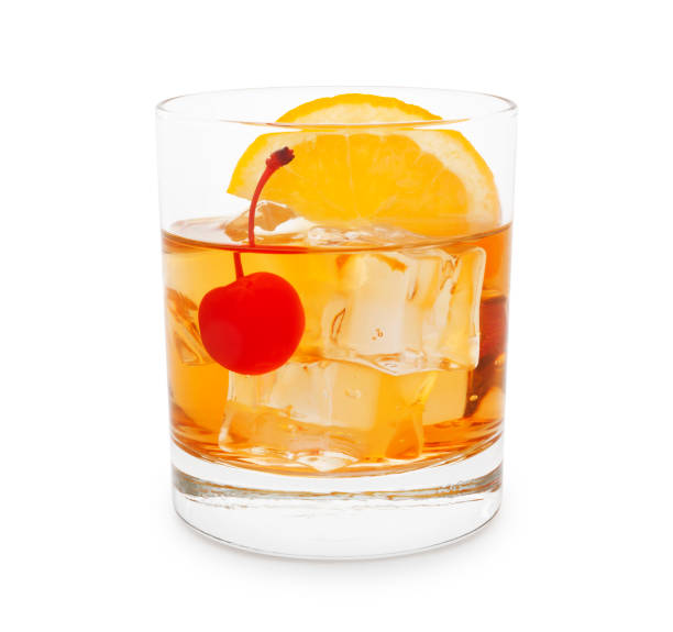 Old-Fashioned Cocktail Old-fashioned cocktail with cherry and orange slice isolated on white manhattan cocktail stock pictures, royalty-free photos & images