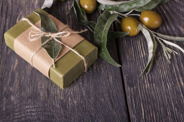 Olive handmade soap with a fresh branch on wooden stock photo