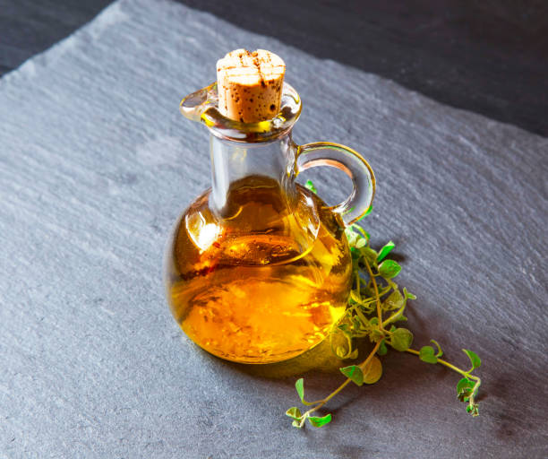 Olive oil bottle with oregano herb stock photo