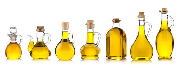 Olive oil bottles collection Collection of seven olive oil bottles in a row isolated on white background. The bottles are arranged in order of increasing size from left to right. olive oil stock pictures, royalty-free photos & images