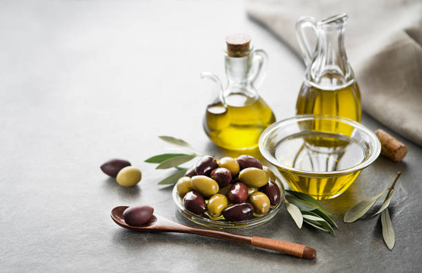 Olive oil Bottle of Extra virgin healthy Olive oil with fresh olives close up olive oil stock pictures, royalty-free photos & images