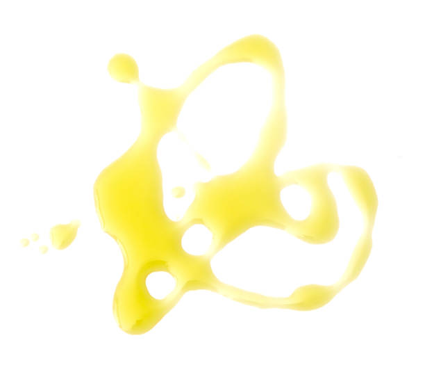 Olive Oil Spilled on a White Background Olive Oil Spilled on a White Background olive oil stock pictures, royalty-free photos & images