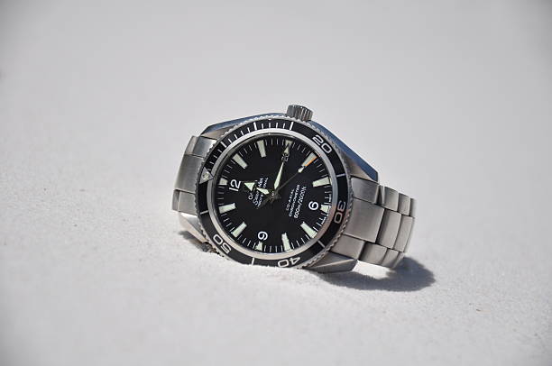 Omega watch on sand stock photo